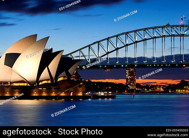 The sun sets over Sydney Harbour in Sydney, Australia