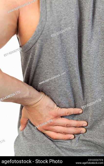 Male hands touching own back