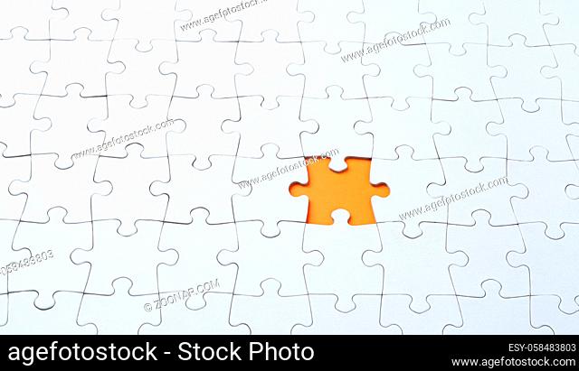 Empty white jigsaw puzzle with missing piece