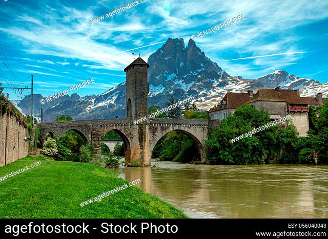 a bridge over river Gave de Pau in Orthez and Pic du midi Ossau - France