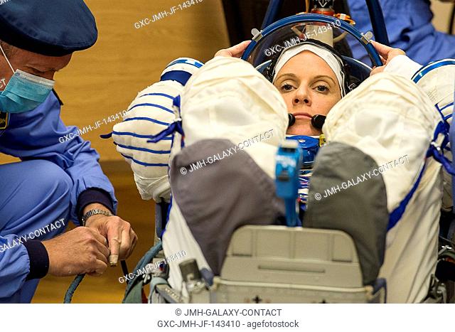 In the Integration Facility at the Baikonur Cosmodrome in Kazakhstan, Expedition 48-49 crewmember Kate Rubins of NASA conducts a leak check of her Russian Sokol...