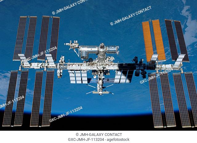 Backdropped by Earth's horizon and the blackness of space, the International Space Station is featured in this image photographed by an STS-134 crew member on...
