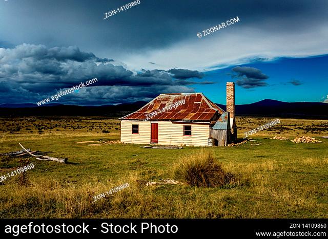 Sunlight and storms at an old hut in Snowy Mountains, Kosciuszko National Park. Note: public building