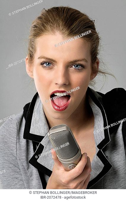 Young woman with a professional broadcast microphone