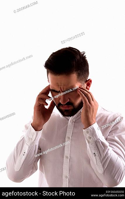 Portrait of thoughtful handsome hipster man posing in studio. Young man in white shirt touching his head isolated on white background