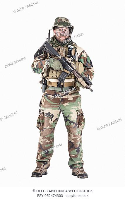 Special forces United States in Camouflage Uniforms studio shot. Holding weapons, wearing jungle hat, Shemagh scarf, painted face