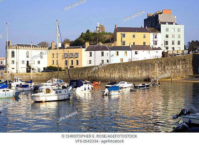 UK, Wales, Pembrokeshire, Tenby, pastel coloured buildings around the harbour in autumn sunshine