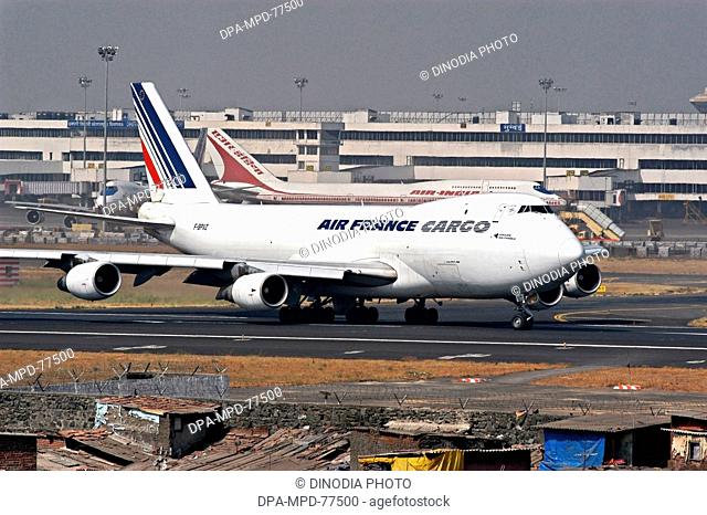 Aeroplane ; An Air-India plane standing at the Chhatrapati Shivaji International Airport terminal while Air France Cargo flight taking off from the runaway of...
