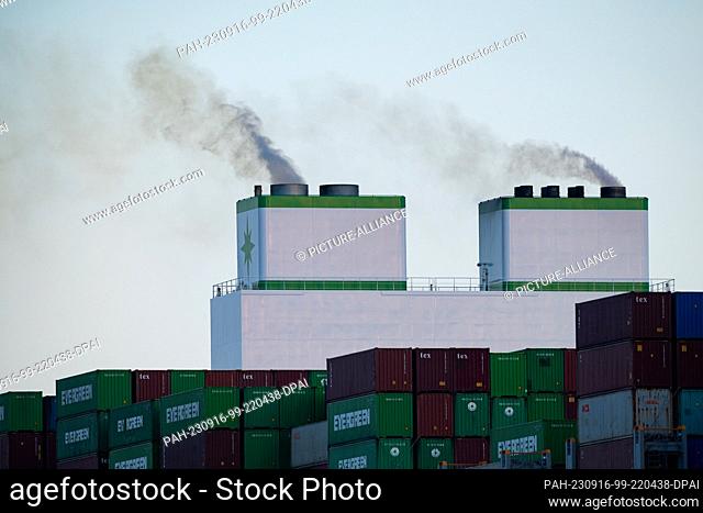 16 September 2023, Schleswig-Holstein, Wedel: Exhaust gases come out of the stacks of the Ever Art container ship of the Evergreen shipping company