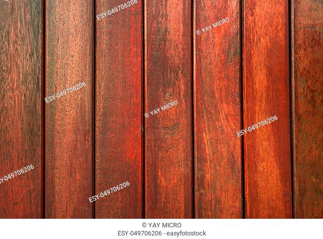 Closeup red wood with unique pattern texture background with copy space for text. Wooden background for construction site