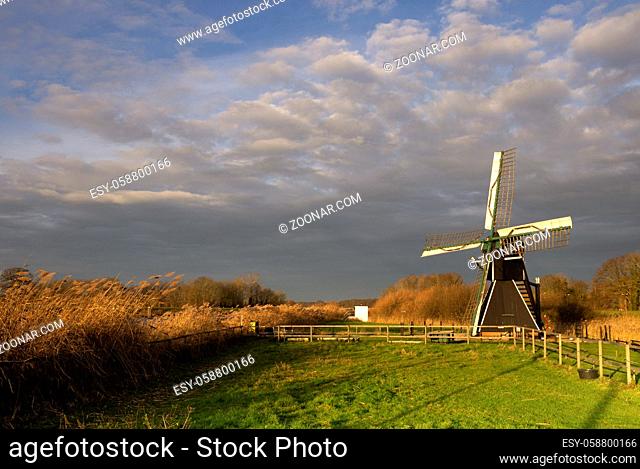 The Follega windmill near the Dutch village Laag-Keppel seen under a heavy clouded sky