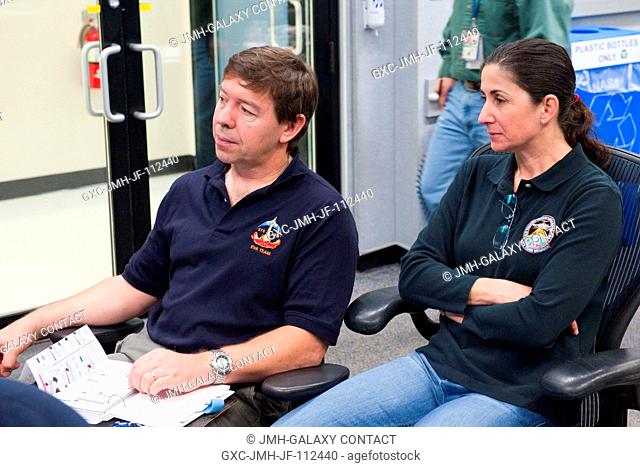 NASA astronauts Michael Barratt and Nicole Stott, both STS-133 mission specialists, participate in a training session in the fixed-base shuttle mission...