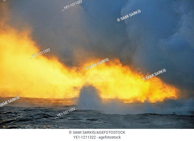 Steam rising off lava flowing into ocean at sunset, Kilauea Volcano, Hawaii Islands, USA
