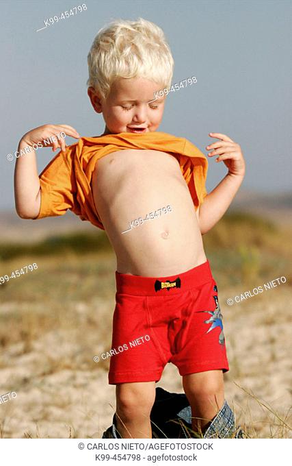 3 year old blond boy playing