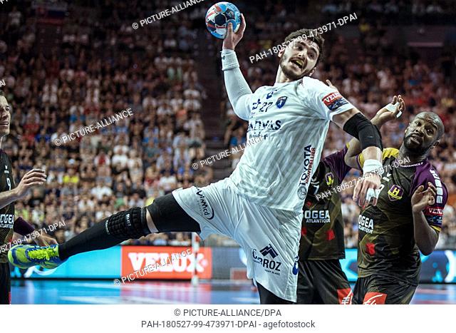 27 May 2018, Germany, Cologne: Handball Champions League final, HBC Nantes vs Montpellier HB at the Lanxess Arena: Rock Feliho (r) of Nantes and Ludovic...
