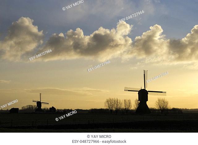 Windmill the Zandwijkse molen near Uppel just before sunset with the Uitwijkse molen in the background