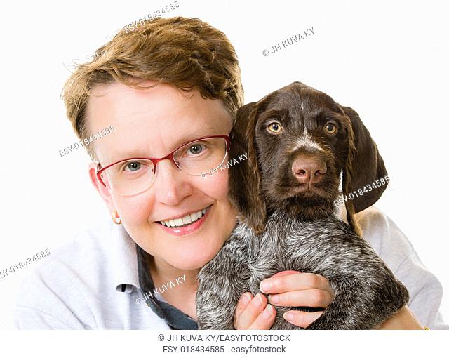 Happy woman and German wirehaired pointer puppy, 12 weeks old, white background, horizon format