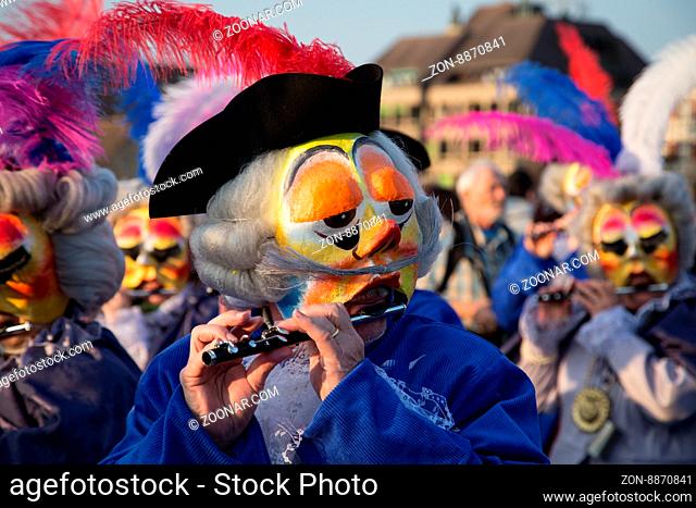 Basel, Switzerland - March 10, 2014: A so called Waggis playing the piccolo at the Basel carnival