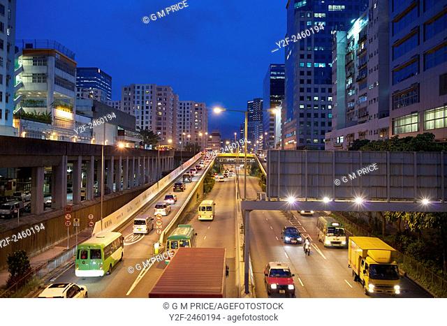 busy motorway and apartments at dusk in Kowloon Bay, China