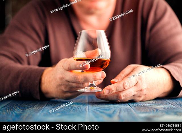 Alcohol abuse, alone man drink whisky for relax