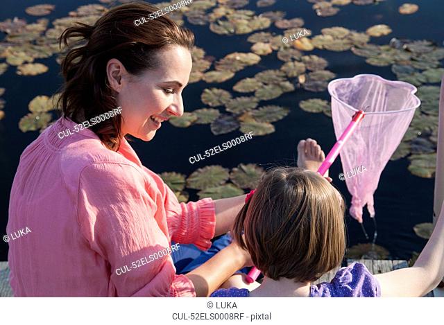 Mother and daughter fishing with net