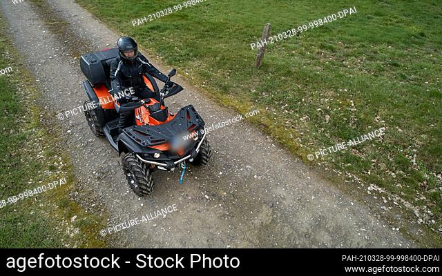 27 March 2021, Rhineland-Palatinate, Nievern: A quad rider is on the road on a dirt track. According to accident expert Brockmann