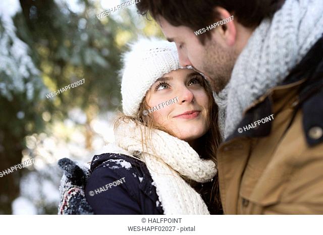 Portrait of hHappy young woman face to face with her partner in winter