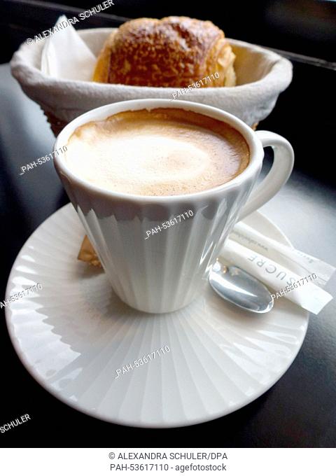 A cup of coffee and a croissant on a table at a restaurant in Paris,  France, 27 August 2014. Photo: Alexandra Schuler - NO WIRE SERVICE - | usage worldwide