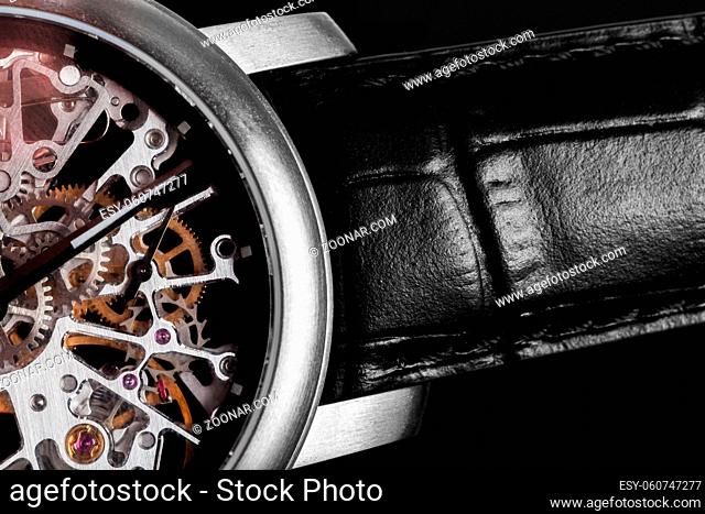 Elegant watch with visible mechanism, clockwork close-up. Luxury, men#39;s vintage accessory. Time, fashion concept