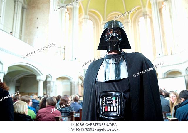 A man dressed up as Darth Vader for the Star Wars church service at the Zionskirche church in Berlin, Germany, 20 December 2015