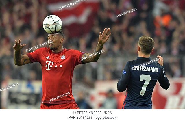 Munich's Jerome Boateng (L) in action against Madrid's Antoine Griezmann during the UEFA Champions League semi final second leg soccer match between Bayern...