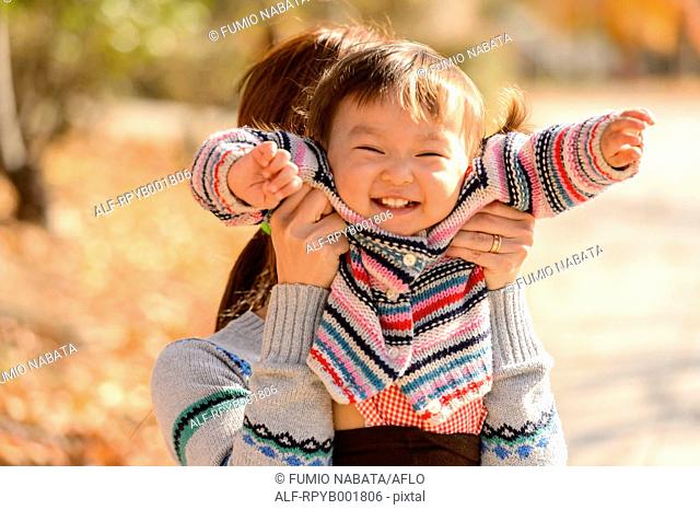 Kid playing with her mother at the park