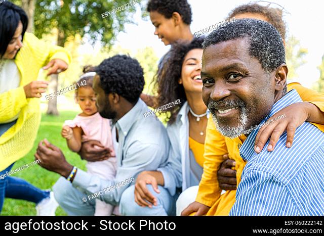 Beautiful happy african american family bonding at the park - Black family having fun outdoors