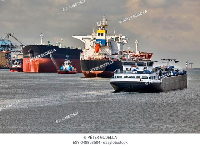 Ship traffic in the busy Port of Rotterdam, large crude oil tanker ship coming into port