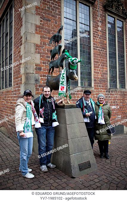 Fans of the local football team of Bremen at the statue of the Bremen Town Musicians. Bremen, Germany, Europe