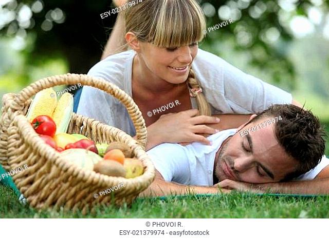 Couple with a basket of produce