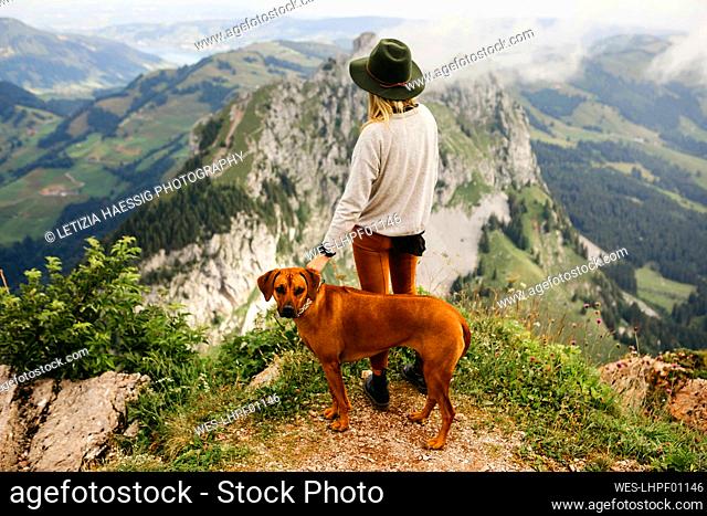 Woman with dog on viewpoint, Grosser Mythen, Switzerland