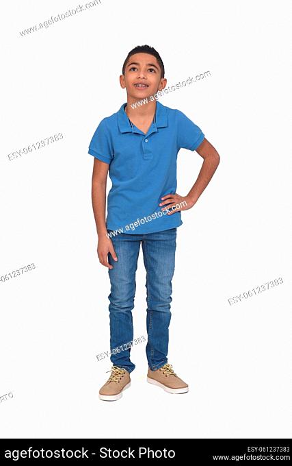 full portrait of boy looking up and hands on hip on white background