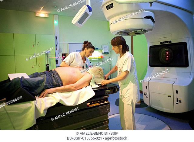 Reportage in the radiotherapy unit of a hospital in Savoie, France. Two technicians set up a patient for a radiotherapy session to treat cervical and dorsal...