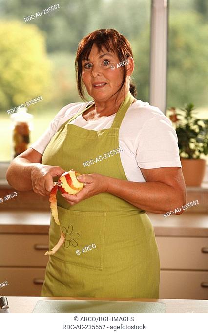 Woman peeling apple / potato peeler