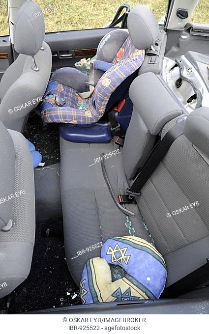 Back seat, child car seat, in accident damaged car