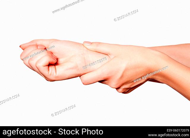 Closeup view of a young woman with pain on hand on white background
