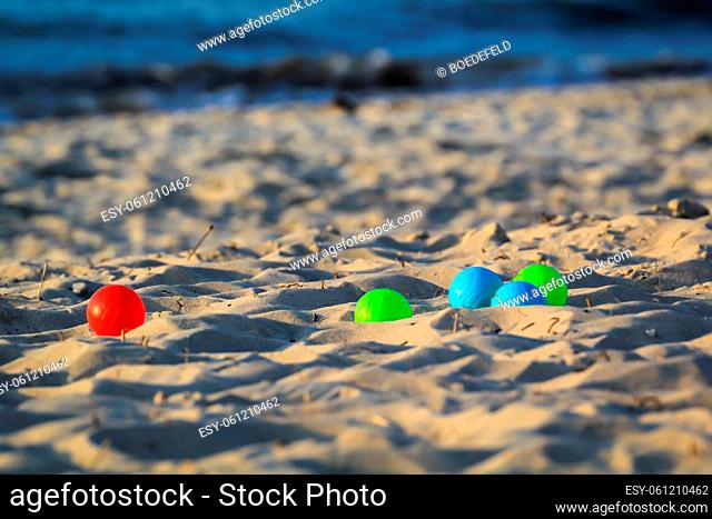 Colored boules balls lying on the beach. Scene of playing boules
