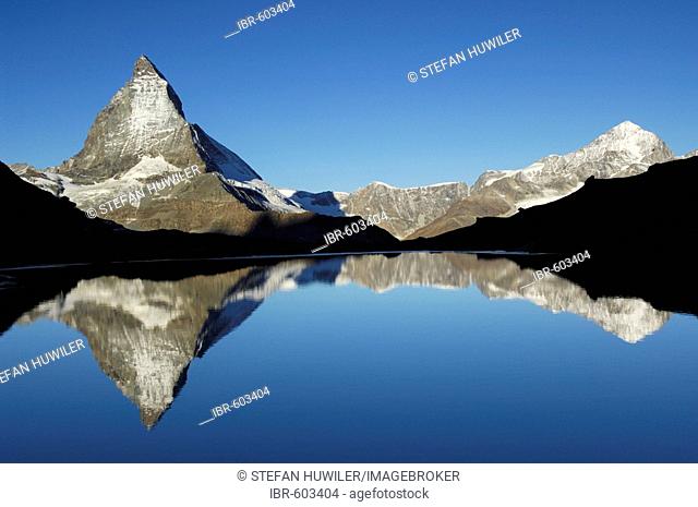 Matterhorn being reflected in the Riffelsee, Zermatt, Valais, Switzerland