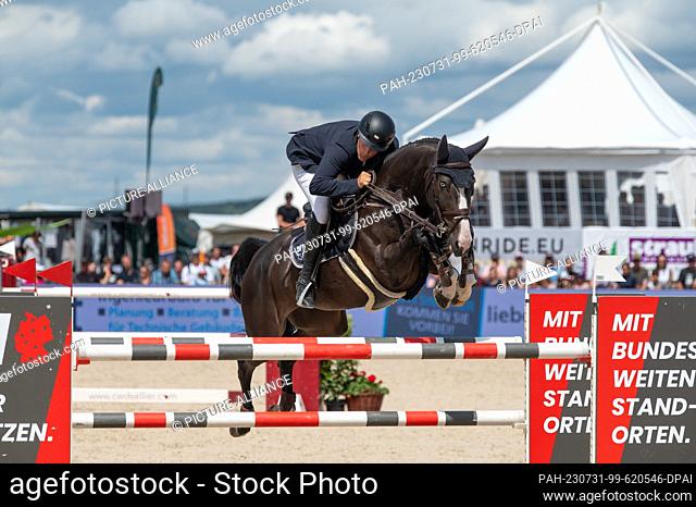 30 July 2023, Baden-Württemberg, Donaueschingen: Equestrian Sports/Jumping: Bemer Riders Tour, Donaueschingen: Felix Müller with his horse Blue Eye in action at...
