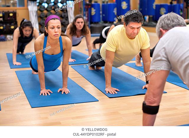 People practicing yoga in studio