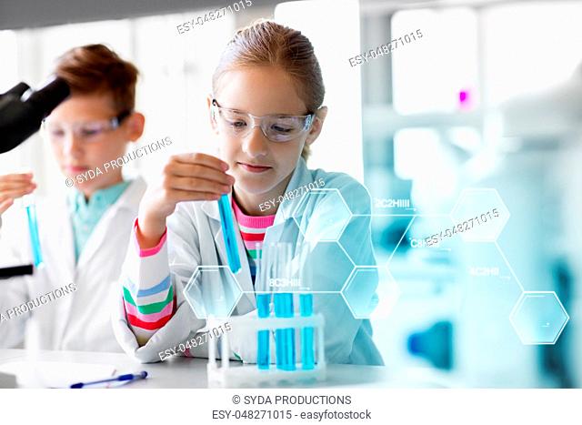 kids with test tubes studying chemistry at school