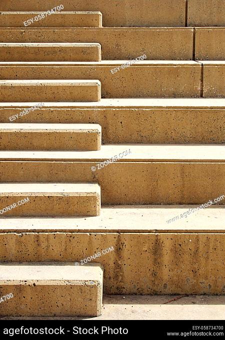 close up of outdoor concrete stairway with geometric shapes in bright sunlight