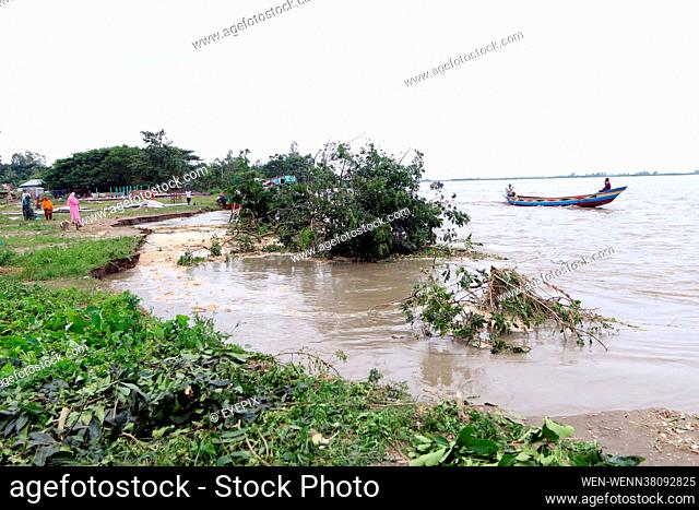Inhabitants from Munshiganj are seen on eroded banks of a river in Munshiganj district, Some 53 km south west of capital Dhaka Bangladesh on 23rd August 2021
