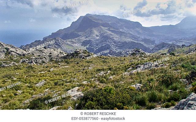 View over the mountains of the Tramuntana Mountains on the Spanish Balearic island of Majorca. In the background the sea and the mountain peaks in the Wolgen